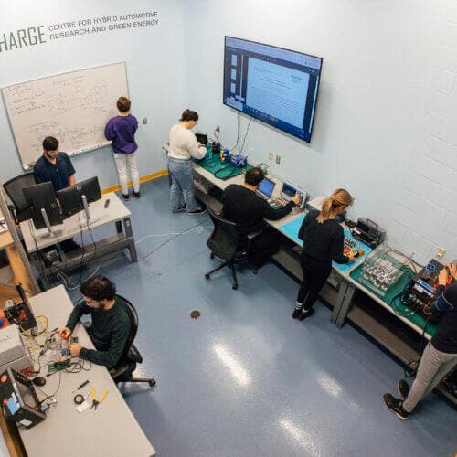 The CHARGE Lab at the University of Windsor with researchers at test benches