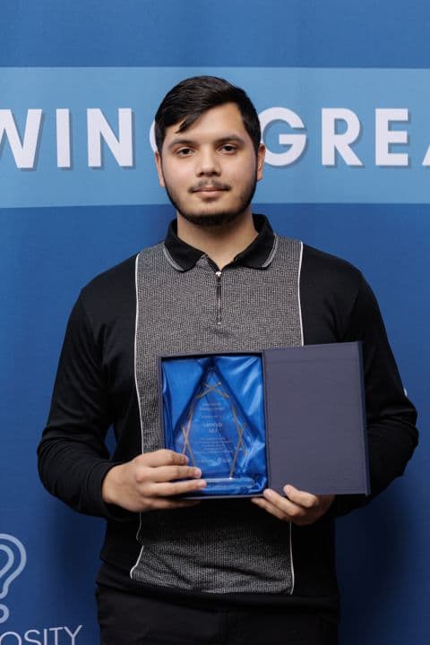 Ahmad holding the EPICentre Innovation Mastery Award